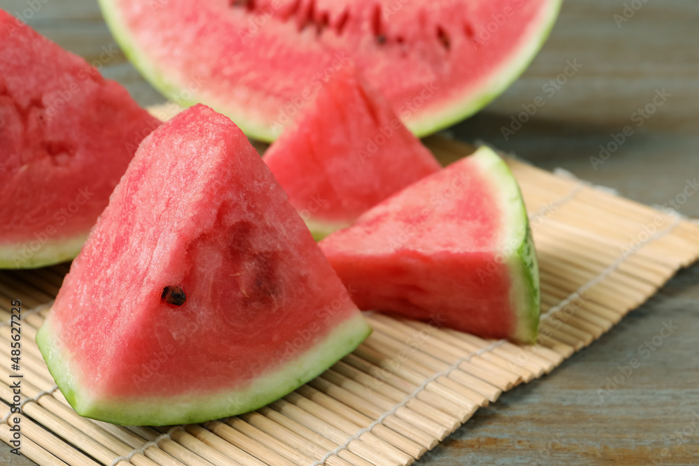 Slices of tasty ripe watermelon on wooden table, closeup Slices of tasty ripe watermelon on wooden table, closeup