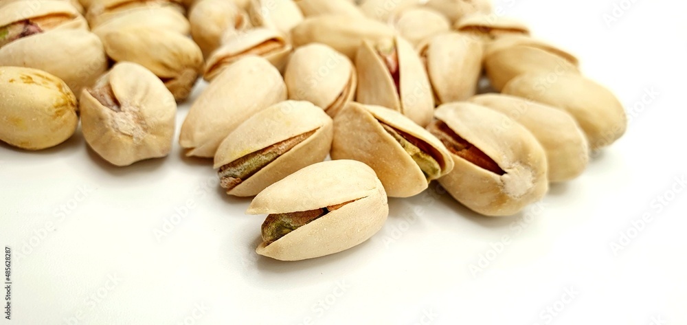Pistachio nuts isolated. Delicious pistachio nuts on a white background. Salted nuts. Pistachio nuts isolated. Delicious pistachio nuts on a white background. Salted nuts.