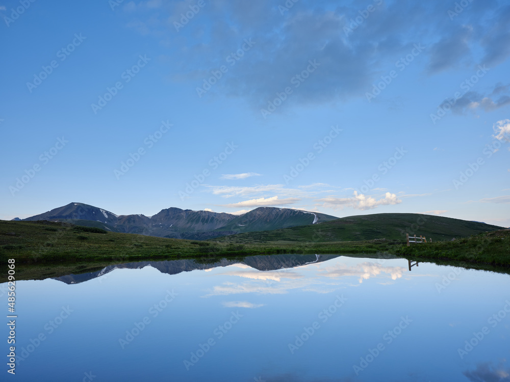 Calm pond or lake with reflections of mountains at the top of the Rocky Mountains on the Continental Divide at 12,095 feet