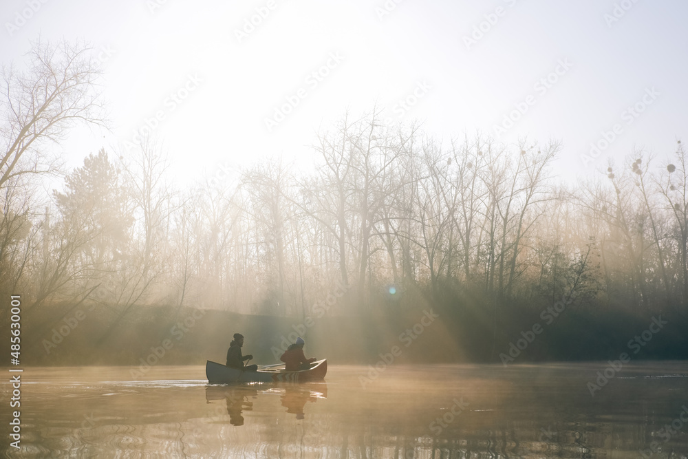 Two men paddling on a beautiful misty river in the morning Stock Photo ...