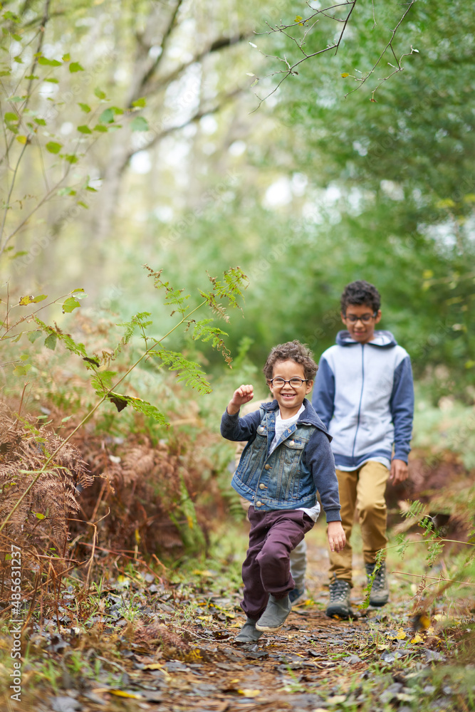 Happy brothers on trail in woods Happy brothers on trail in woods