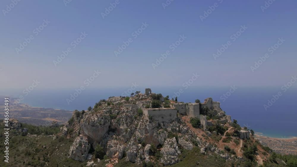 Aerial 4K landscape view of medieval Kantara Castle which is located at the Mountains in North Cyprus. Medieval Castle is surrounded with rocks & trees with an amazing view of Mediterranean Sea. Aerial 4K landscape view of medieval Kantara Castle which is located at the Mountains in North Cyprus. Medieval Castle is surrounded with rocks & trees with an amazing view of Mediterranean Sea.