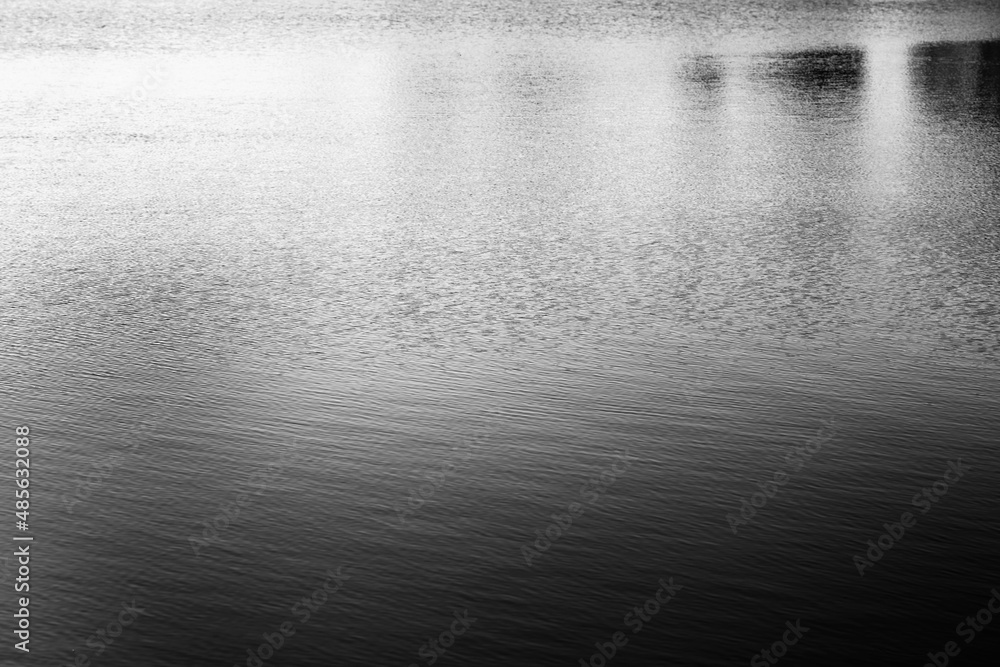 Black and white grain texture water wave refraction. Light and shadow smoke abstract copy space background. Black and white grain texture water wave refraction. Light and shadow smoke abstract copy space background.