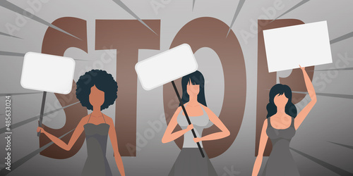 Girls with a banner in their hands against the background of the word STOP. The concept of expressing thoughts, dissatisfaction and protests.