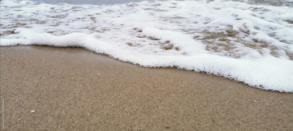 Detail of small waves arriving at the shore of the beach. Relaxation and peace Detail of small waves arriving at the shore of the beach. Relaxation and peace