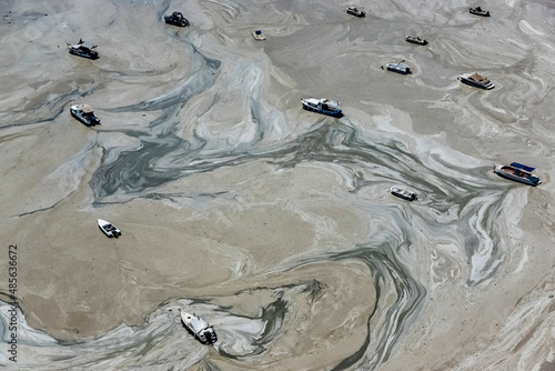 Aerial view of boats in mucilage (gluey substance produced by excessive microorganisms due to pollution) at the Marmara Sea coast of Istanbul, Turkey.