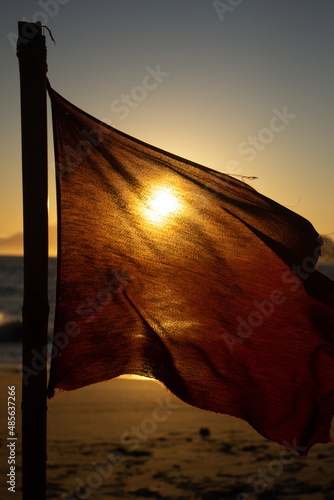 Red flag over the sun 