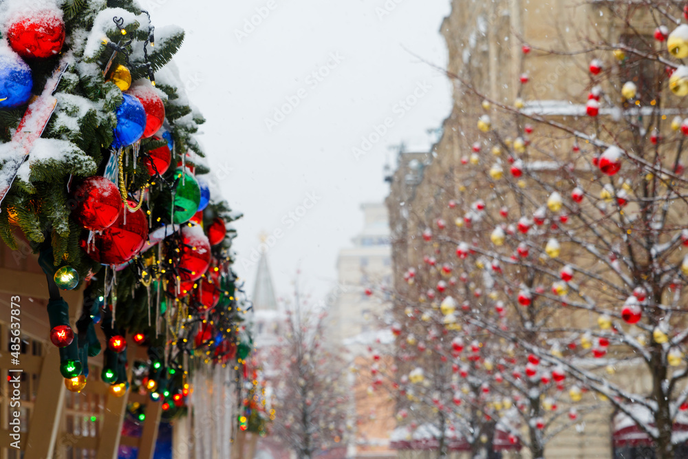 Moscow, Russia, February 7, 2022, fair on Red Square on a winter morning, it is snowing. Christmas street decorations. A beautiful image of New Year's Moscow