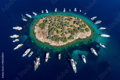 Aerial view of anchored boats around an island in Turkbuku, Bodrum, Turkey.
