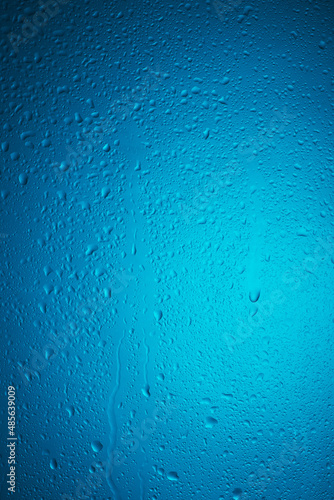 water drops on glass on a blue background