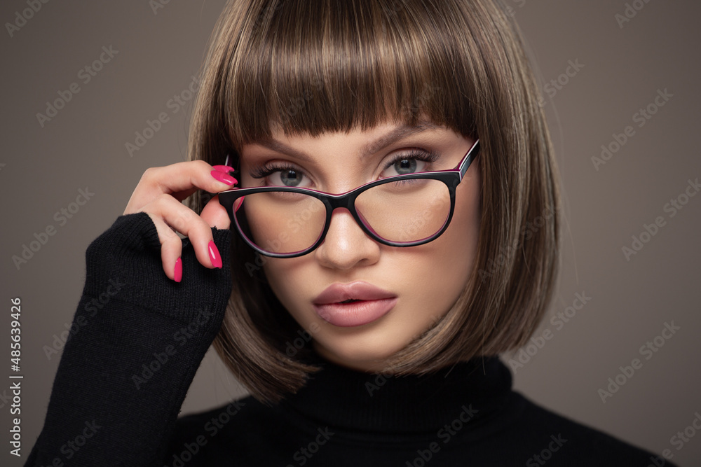 Portrait of a business woman in strict glasses. Short haircut. Portrait of a business woman in strict glasses. Short haircut.