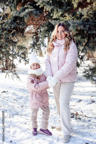 A little daughter and mother gently hug, kiss, showing love and expressing affection.Happy family, the pleasure of being a mom, congratulations on Mother's Day, the concept of a sweet moment together
