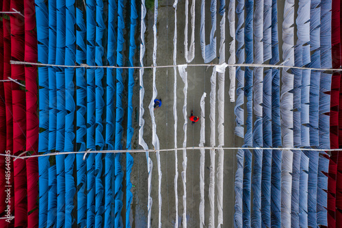 Aerial view of workers hanging coloured t-shirt fabrics to dry in Narayanganj, Dhaka, Bangladesh. photo