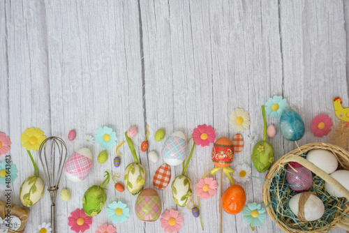 Moscow, Russia, February 2022, spring easter card, multi-colored flowers, easter eggs in a basket background