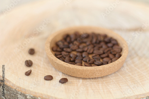 Cafe concept. Coffee beans on natural wooden table and background, trendy design background concept. Coffee business photo