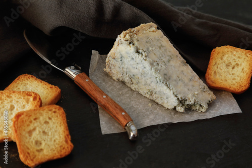 Cabrales, spanish blue cheese and bread on dark background