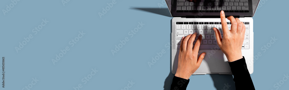 Person using a laptop computer from above - obrazy, fototapety, plakaty 