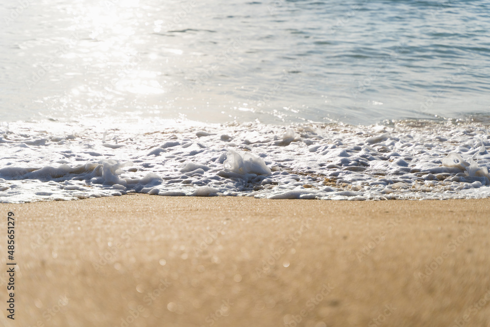 Sea wave by shore on beach with sun reflection on water. Natural landscape Sea wave by shore on beach with sun reflection on water. Natural landscape