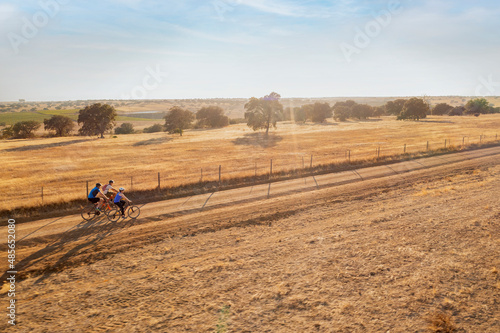 Aerial view of people cycling a bike in countryside at sunset, Beja, Portugal. photo