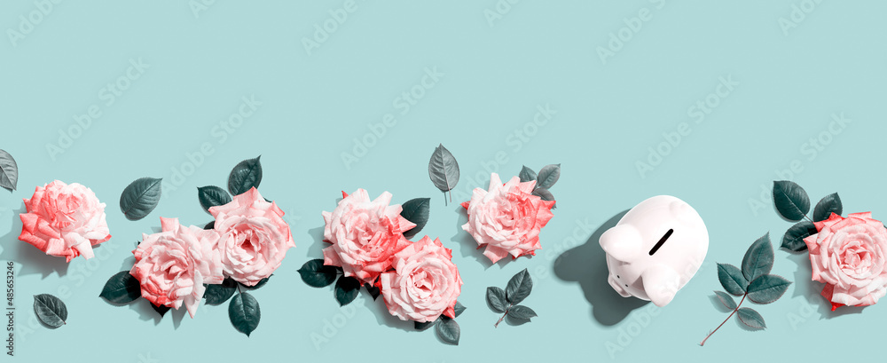 Piggy bank with pink roses overhead view - flat lay Stock Photo | Adobe