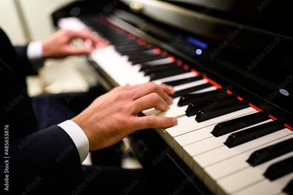 Obraz premium Close up of a musician playing a piano keyboard