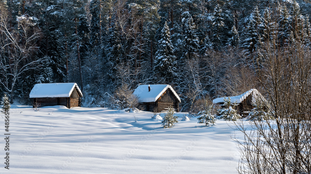 Rural landscape with village huts covered with white snow in winter. Rural landscape with village huts covered with white snow in winter.