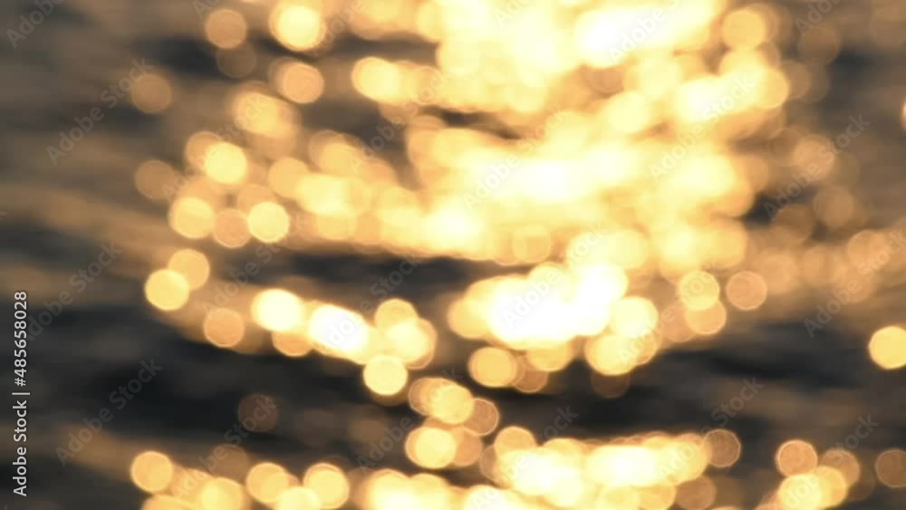 Blurred orange sea at sunset. Sun reflects and sparkles on waves with bokeh lights. Slow motion FullHD video. Abstract summer natural background. Copy space for your text. Blurred orange sea at sunset. Sun reflects and sparkles on waves with bokeh lights. Slow motion FullHD video. Abstract summer natural background. Copy space for your text.