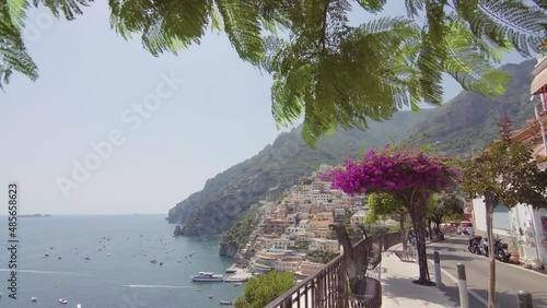 A panoramic view of the Positano on the Amalfi Coast, Italy. Sunny day, coastline, cliff, sea, boats, beautiful day, scenic, Italian architecture, gimbal camera move - 4K Video Footage