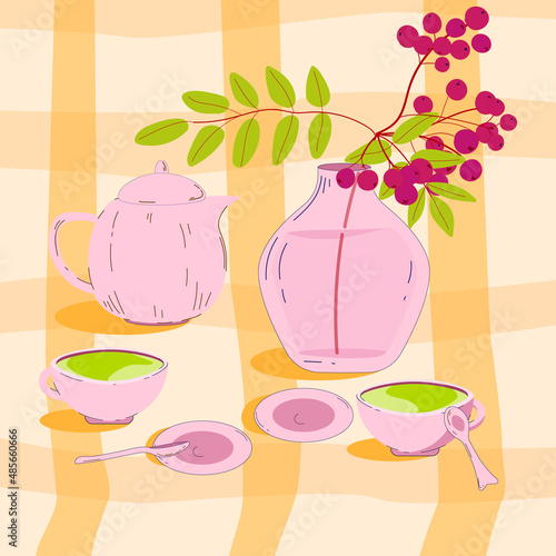 Cups of tea and a vase of rowan berries are on the tablecloth