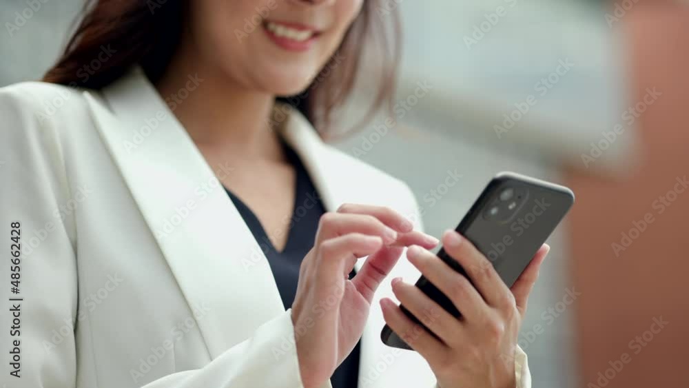 Close up business hand woman using mobile phone to play social media in the buildings at downtown. Smart female using cell phone chatting for business communication. Smartphone concept. Close up business hand woman using mobile phone to play social media in the buildings at downtown. Smart female using cell phone chatting for business communication. Smartphone concept.