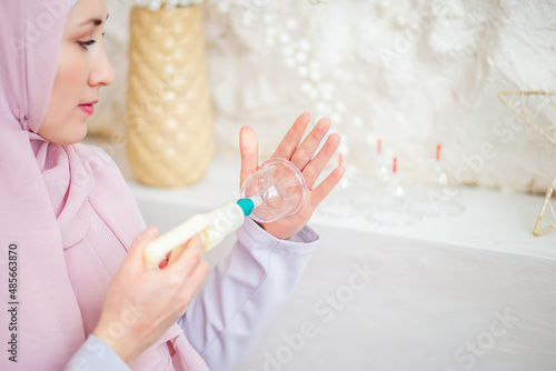 Young muslim woman doing vacuum therapy.