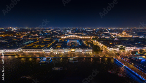 The picturesque night landscape of Winter Palace and Palace square with night illumination, night illumination of buildings and streets, many boats