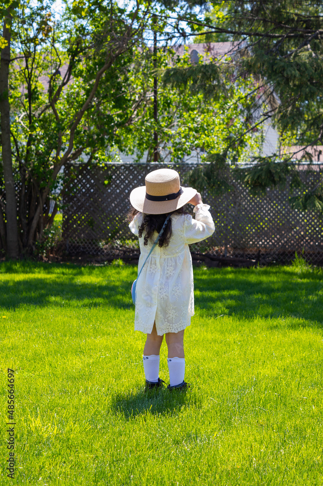little girl enjoying nature in summer