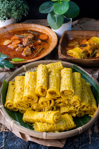Malaysian traditional dish called Net Pancake or Roti Jala served with lamb or mutton curry. Selective focus shot.
