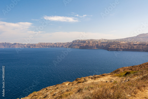Fototapeta Naklejka Na Ścianę i Meble -  Santorini coast and blue sea. View of the caldera from the peninsula of Akrotiri. Greece