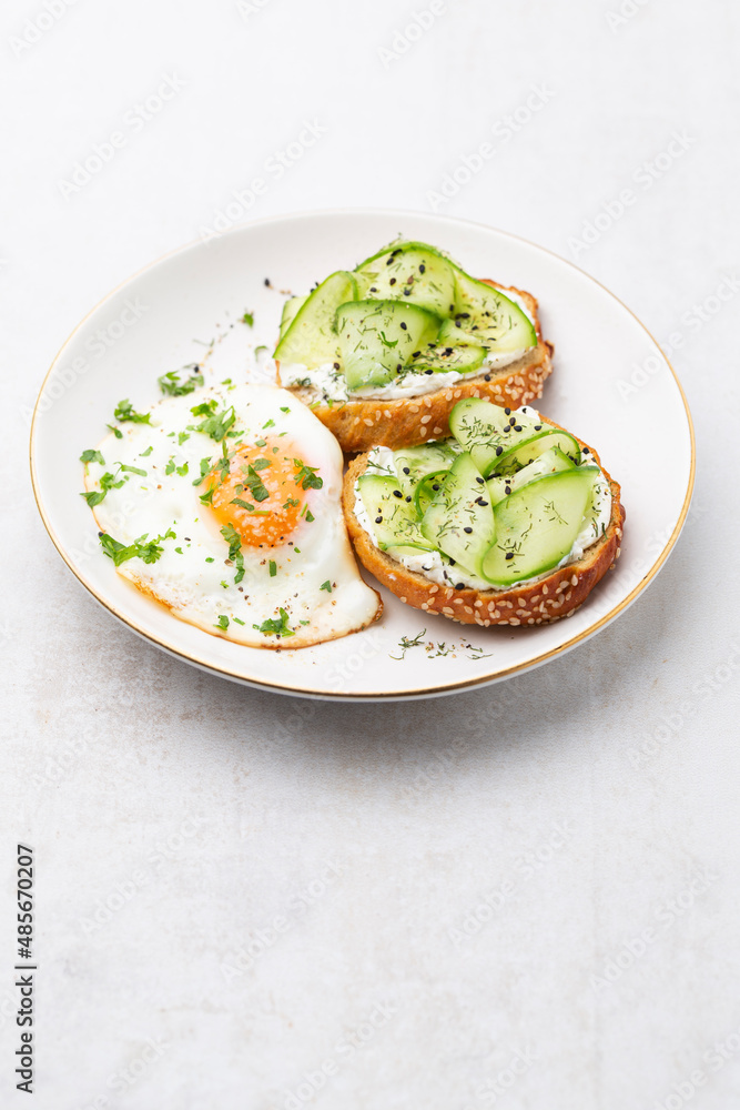 Keto Toasts with ricotta, egg, cucumber and black sesame. Keto Toasts with ricotta, egg, cucumber and black sesame.