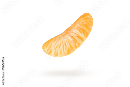 A piece of mandarin isolated on a white background, falling casting a shadow. Individual segments of tangerine slices, for inserting into a project or design.