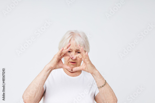 Photo of retired old lady in a white t-shirt light background