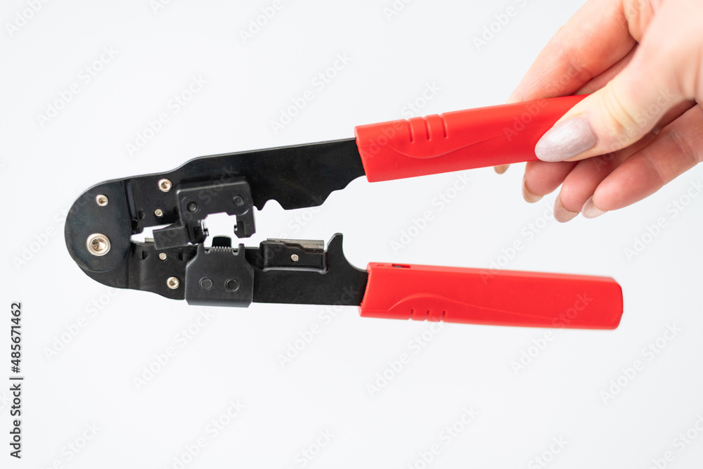 female hand holding Crimping pliers for connectors, internet cables and wires female hand holding Crimping pliers for connectors, internet cables and wires
