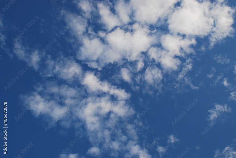 A small white cloud in a clear blue sky. Small cumulus clouds float across the light blue sky. They form a small group next to each other. Clouds of various shapes and sizes. A small white cloud in a clear blue sky. Small cumulus clouds float across the light blue sky. They form a small group next to each other. Clouds of various shapes and sizes.