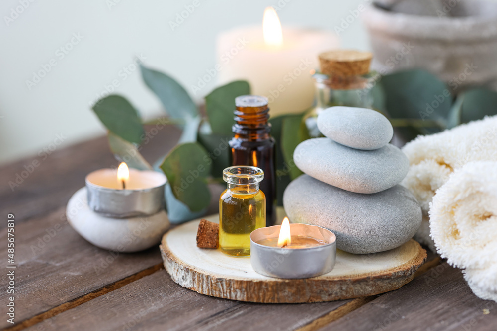 Assortment of natural oils in glass bottles on wooden background. Concept of pure organic ingredients in cosmetology. Bath accessories, atmosphere of harmony, relax. Close up macro. Healthy lifestyle Assortment of natural oils in glass bottles on wooden background. Concept of pure organic ingredients in cosmetology. Bath accessories, atmosphere of harmony, relax. Close up macro. Healthy lifestyle