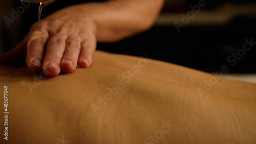 Close-up of a back massage at a spa. A woman is getting a back massage.