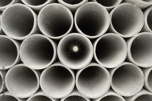 Pipes at the hardware store used for the construction. Close up concrete, cement pipes stacking, pattern background. Asbestos pipes for irrigation.
