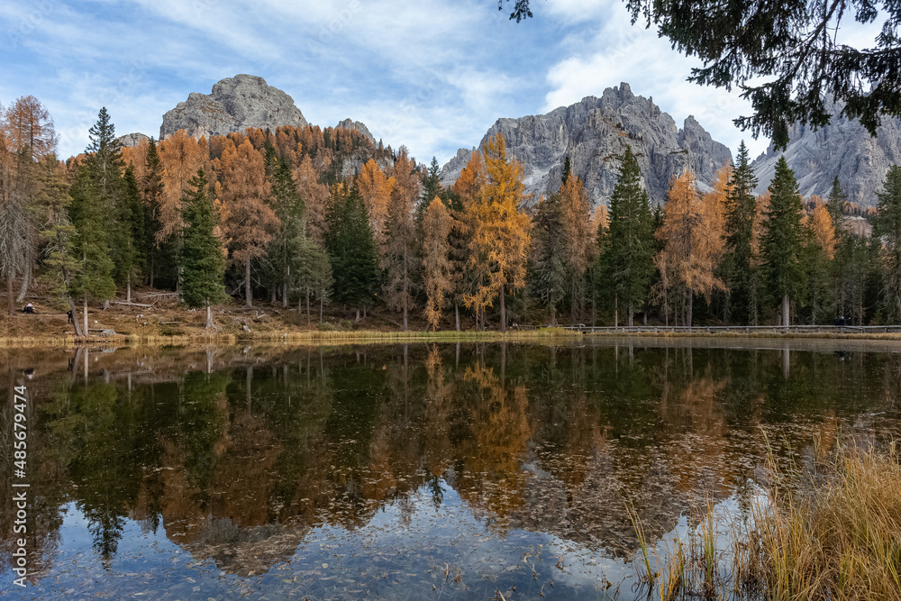 Reflections of the mountains and trees with autumn colors on Lake Antorno, with the TCadini di Misurina in the background, Dolomites, Italy
