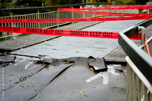 Red tape reading 'danger keep out' preventing people crossing a bridge. Taken in Christchurch after the earthquake which struck on 22nd February 2011.