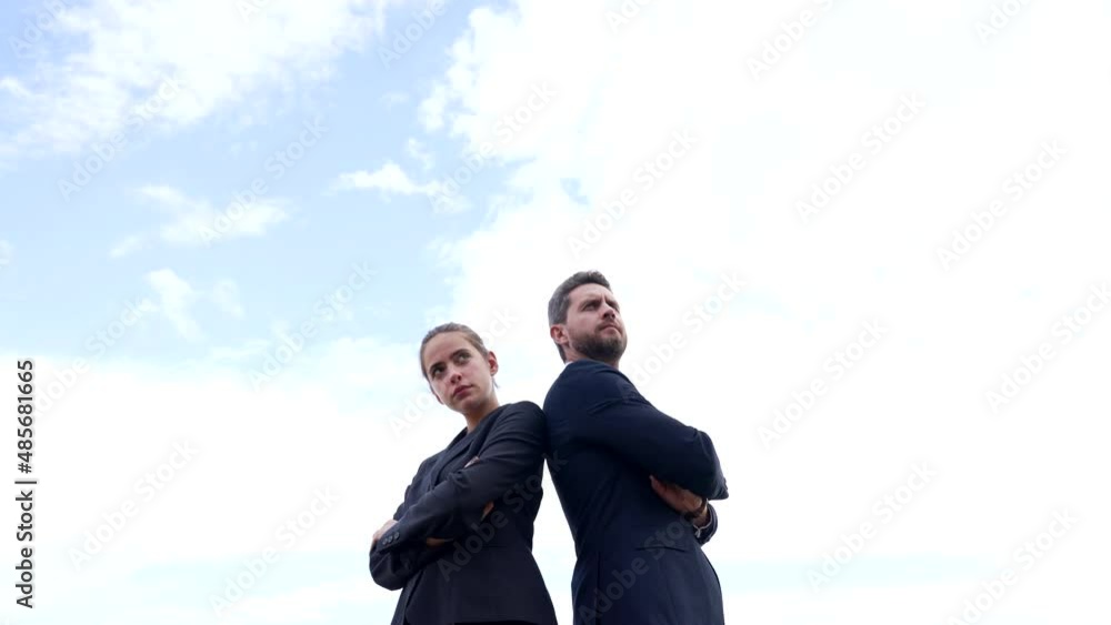 Ambitious business couple of serious guy and girl on sky, ambitions Ambitious business couple of serious guy and girl on sky, ambitions