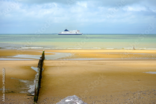 car ferry on the english channel between Dover and Calais seen from the beach