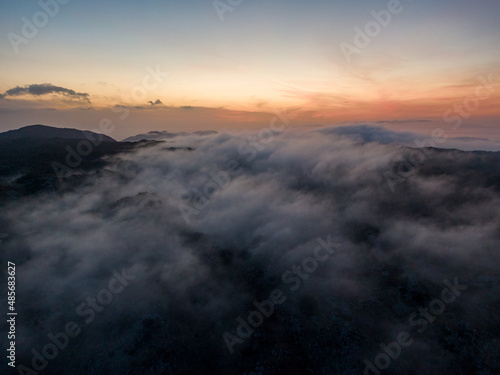 Aerial droen view of beautiful clouds with sunset  in mountain © ernestos