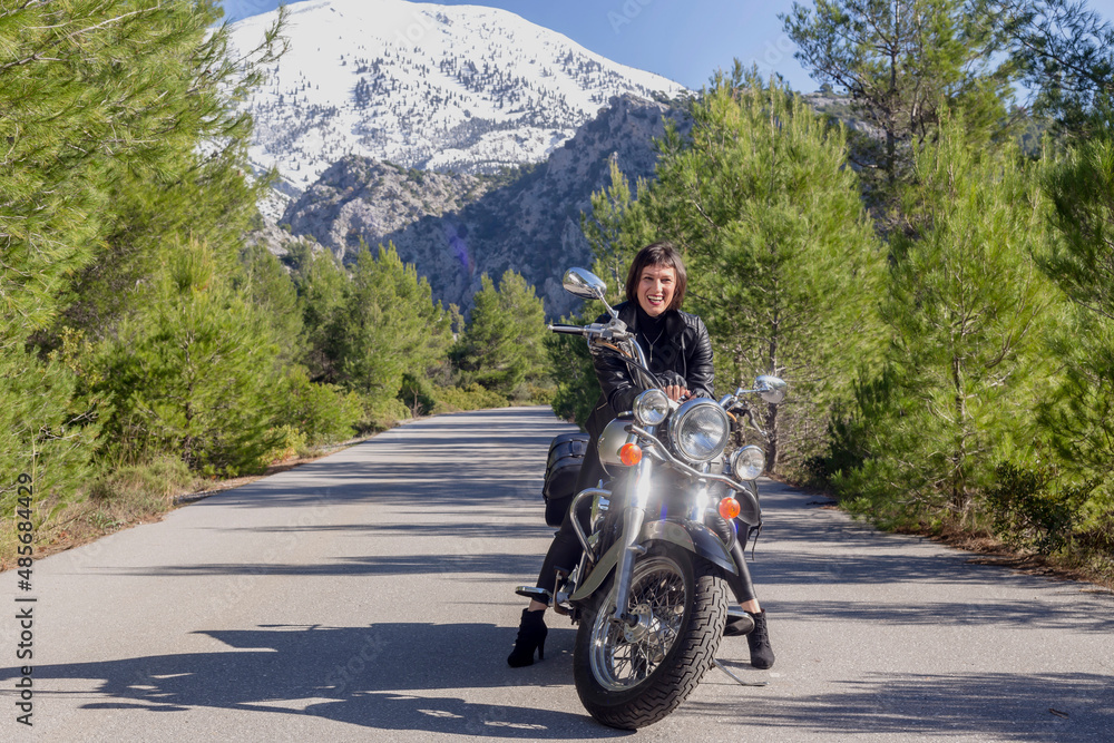 Young beautiful Greek woman sitting on a motorcycle close-up Young beautiful Greek woman sitting on a motorcycle close-up