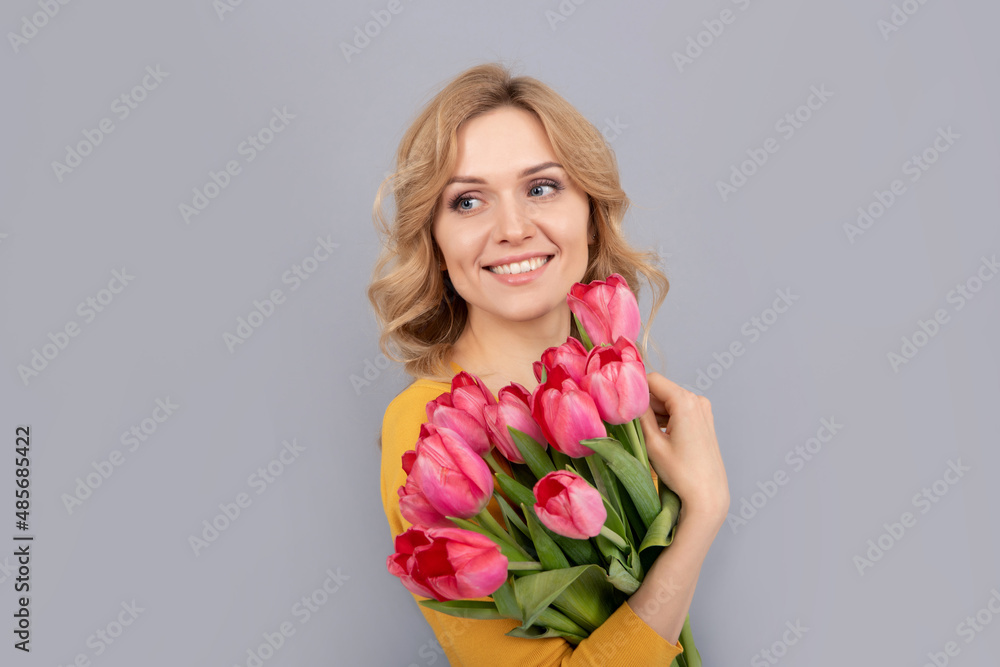 positive woman with tulips on grey background positive woman with tulips on grey background